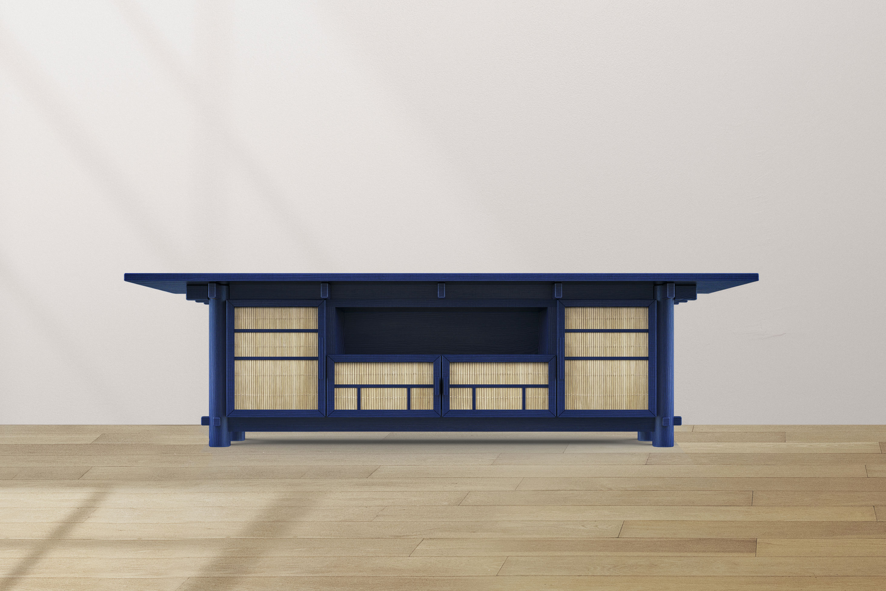 An architectural model which has blue support structured - roof, plyons and railings, and straw-coloured mats that are a barrier to the outside. The model sits on a blonde-wooden floor and against a white wall.